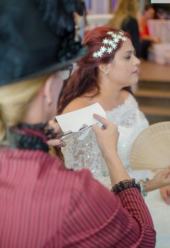 Kathryn Flocken cutting a bride's silhouette at a wedding